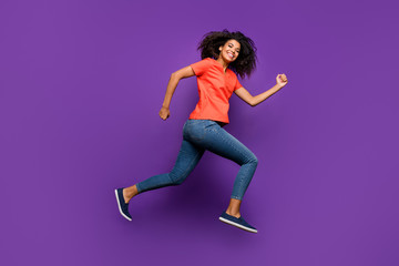 Full length body size photo of side profile curly wavy cheerful nice pretty youngster running forward to shopping mall before holidays isolated over vivid color violet background
