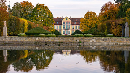 Fototapeta na wymiar Abbots Palace in the rococo style and located in Oliwa Park in autumn scenery.. Gdansk, Poland.