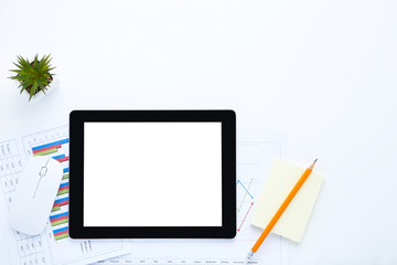 Tablet computer with mouse, pencil and paper with graphs on white background