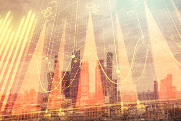 Double exposure of financial graph on downtown veiw background. Concept of stock market research and analysis