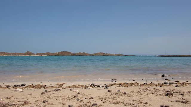 Playa De La Concha De Lobos, shallow, tropical beach ideal for relaxing or swimming on the uninhabited oasis island of Los Lobos, a small isle located north of Fuerteventura, Canary Islands, Spain