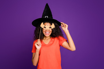 Photo of cheerful positive cute charming nice overjoyed girlfriend pretending to be witch in mask...