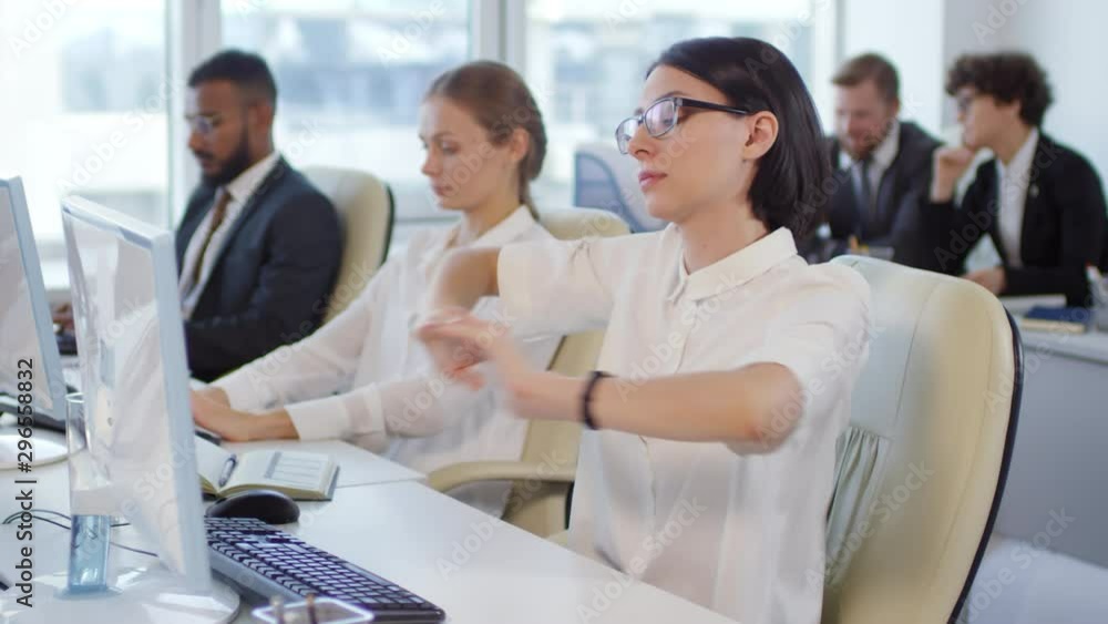 Poster lockdown of office workers sitting at desks and working on computers. caucasian brunette businesswom