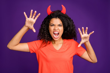 Photof of horrible terrifying mad insane occultist spooky attempting to frighten you with her frightful grimace on face roaring loudly in orange t-shirt isolated vivid violet color background