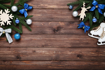 Christmas tree branches with toys on brown wooden table