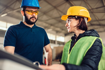 Workplace safety inspector writing a report at industrial factory