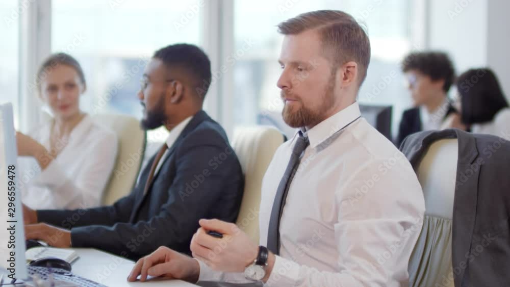 Poster lockdown of businesspeople sitting at desks, working while caucasian businessman starting warming up