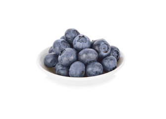 whole fresh blueberries in small bowl on white background