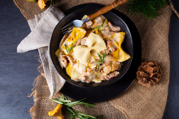 Colorful farfalle pasta with chanterelles and cream sauce.