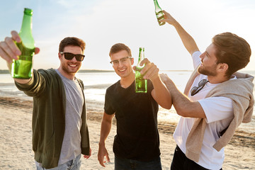 friendship and leisure concept - group of happy young men or male friends toasting non alcoholic...