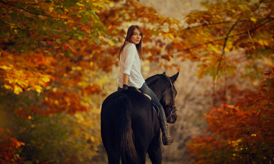 Young girl riding a horse.