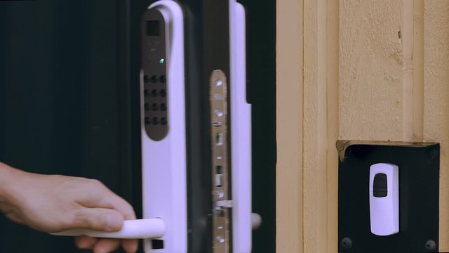 Close up view of an electric combination lock on a black door. Interior design. Beautiful backgrounds.