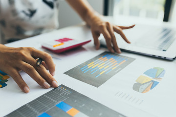 Business investment concept . Business woman he working with document finance graph and analysis graph stock market trading with stock chart data.