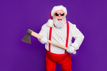 Fototapeta na wymiar Profile side view portrait of his he nice crazy funky cheerful cheery fat thick bearded Santa holding in hands ax ready to cut isolated on bright vivid shine vibrant violet lilac background