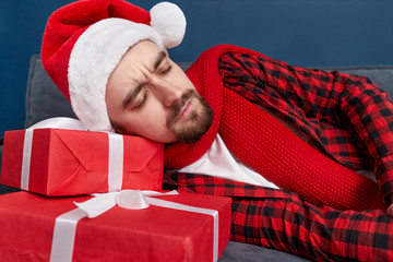 Drunk man sleeping on Christmas gifts