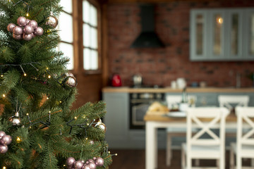 Fototapeta na wymiar Christmas spirit with decorated tree in the kitchen