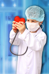 child in a white doctor’s coat, hat and mask attached a stethoscope to a red heart model, background clinic, close-up, focus on the face, medical concept, cardiology