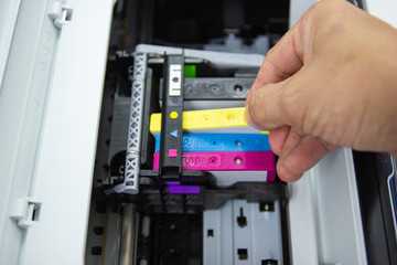 Technicians are install setup the ink cartridge or inkjet cartridge is a component of an inkjet printer 
