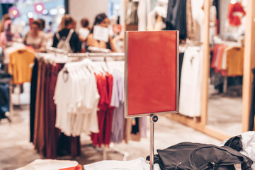 Mock up template of sales information banner or tag price in clothing store. Frame with copy space.