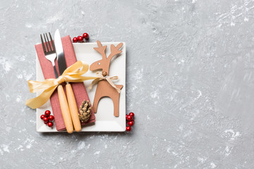 Top view of holiday dinner decorated with dried fruit and cinnamon on cement background. Set of...