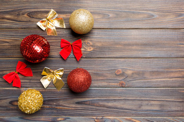 Top view of Christmas balls and creative decorations on wooden background with copy space. New Year...