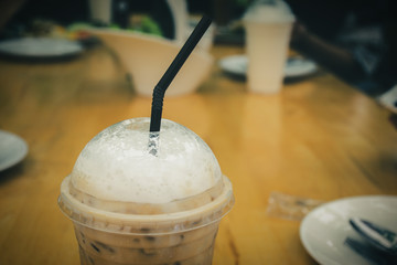 Close up of Ice coffee on wooden table background in restaurant.