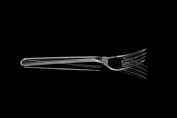 Transparent plastic fork isolated on black background