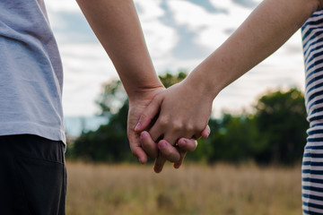 A lesbian couple holding her hands