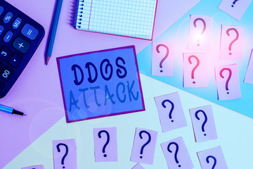Handwriting text Ddos Attack. Conceptual photo perpetrator seeks to make network resource unavailable Mathematics stuff and writing equipment above pastel colours background