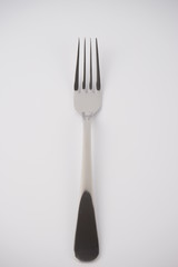 closeup of a fork on white background