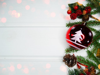 christmas decoration and garland lights on white wooden background