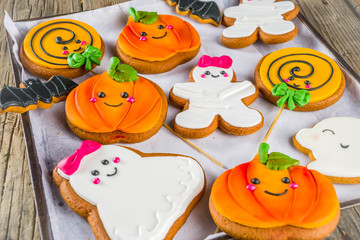 Halloween background with Funny Gingerbread Cookies - pumpkins mummy, zombies, ghosts, spiderweb. Top view with copy space.