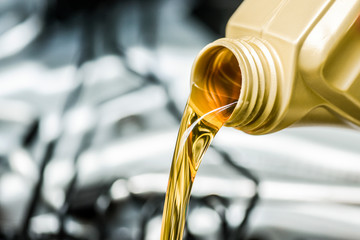 Pour motor oil to car engine. Fresh yellow liquid change with back light. Maintenance or service...