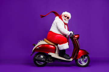 Photo of fat santa claus role man rushing newyear x-mas theme party by bike cool modern style wear...