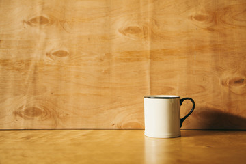 white cup on a wooden background. engineering background.