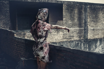 Ghost nurse woman or zombie standing waved hand to outside in the building abandoned hospital.