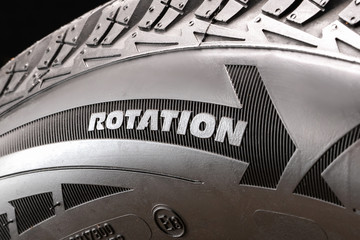 rotation-arrow indicating the rolling direction of the tire to properly install the wheel on the car. the designation on the sidewall of the tire.