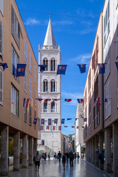 Fototapeta Cathedral church bell in Zadar Croatia. Festive streets of Zadar Croatia. Festive flags hanging on the street.