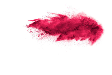 Red powder explosion cloud on white background. Freeze motion of red color dust  particles splashing.