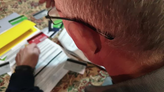 A man is looking at debts and credit cards. Debt credit accounts