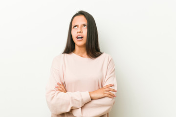 Obraz premium Young cute hispanic teenager woman tired of a repetitive task.
