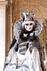 Fototapeta na wymiar Female carnival mask in Piazza San Marco in Venice during the carnival. Italy
