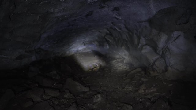 Beams of lanterns illuminate a niche in the cave