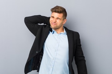 Young handsome caucasian man suffering neck pain due to sedentary lifestyle.