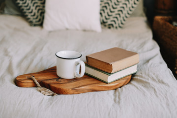 Books and coffee cup. Breakfast in bed.  Good morning. Atmospheric hygge style. flat lay, still life