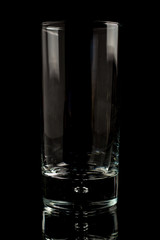 A glass of beer in a black scene