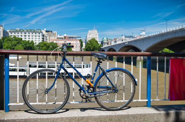 Fototapeta premium Parked bike along River Thames in London, summer season
