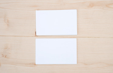 Blank template for branding identity of white business name card for mock up process on wooden table background.