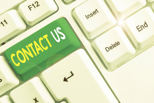Word writing text Contact Us. Business photo showcasing Group of demonstrating that rendering costumer service through telecom White pc keyboard with empty note paper above white background key copy