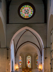 Medieval architecture. Church interior with altar and stained glass